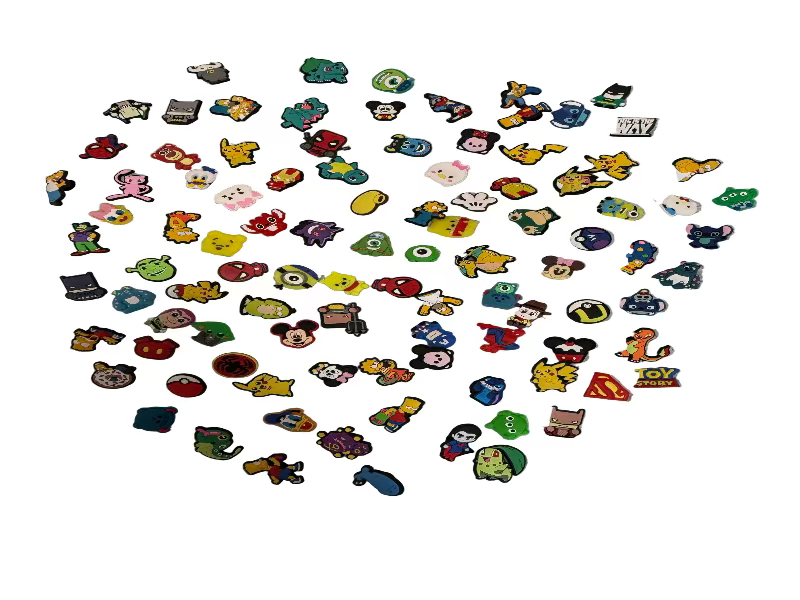 Collection of small colorful pins on a textured surface